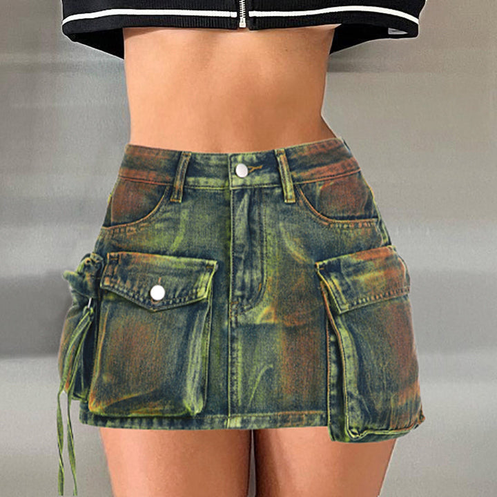 Une femme portant une jupe cargo en jean bleu vert avec des poches avant. Coupe droite pour une silhouette féminine urbaine. Disponible du S au L.