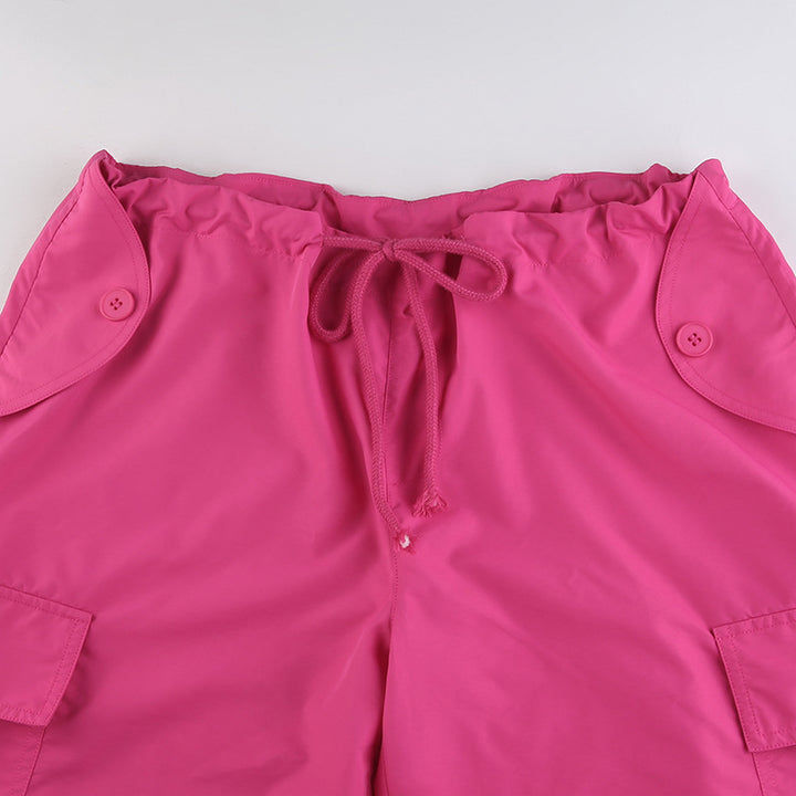 Pantalon cargo baggy taille basse - Rose - Femme, avec poches et boutons. Coupe large façon parachute, lanières pendantes. Confortable et extensible grâce au mélange de polyester, jersey et spandex. Disponible du S au L.