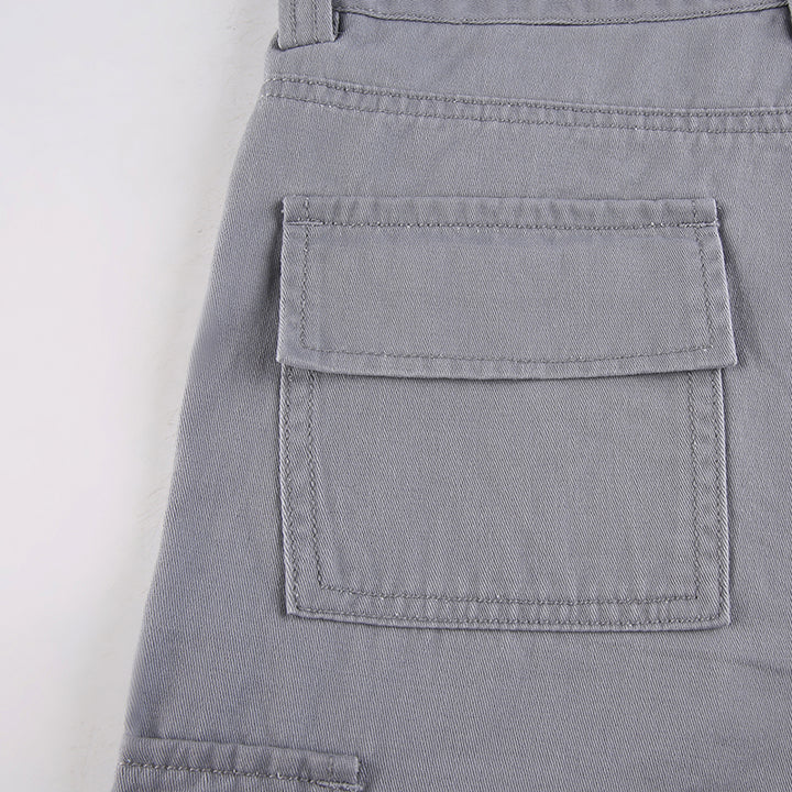 Un gros plan sur une poche de Pantalon cargo ajusté flare gris pour femme de Cargo District. Les poches utilitaires ajoutent une touche street à votre look.